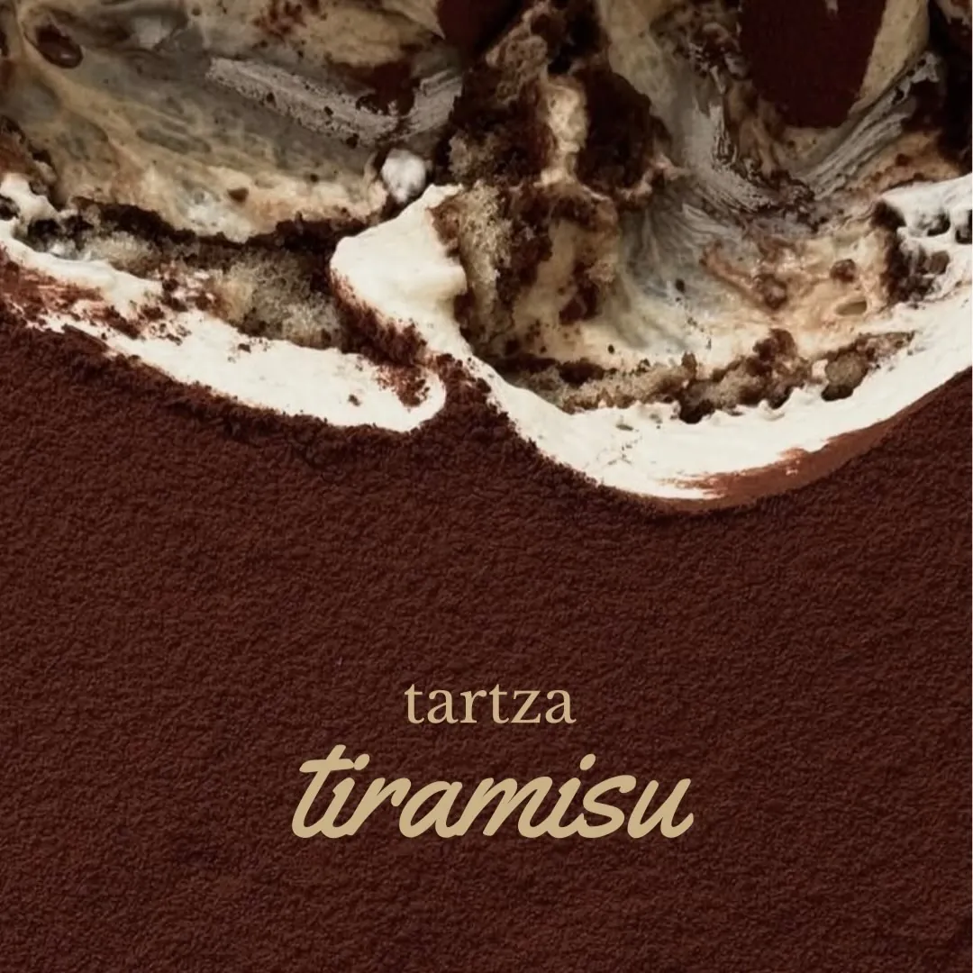 Tiramisu tartza close up: mascarpone cream under a dusting of cocoa